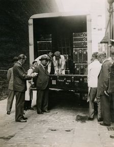 Zheng Tianxin (Dr Cheng) watching the unloading of cases in the West Yard at Burlington House, 1935. Creator: Topical Press Agency