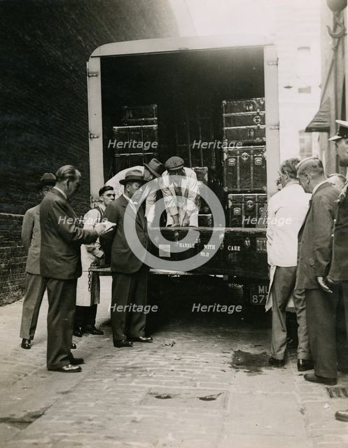 Zheng Tianxin (Dr Cheng) watching the unloading of cases in the West Yard at Burlington House, 1935. Creator: Topical Press Agency.