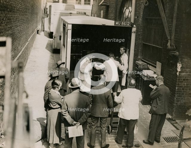 Zheng Tianxin (Dr Cheng) with vans and staff from Bishop & Sons Depositories...Burlington House,1935 Creator: Topical Press Agency.