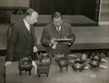 Zheng Tianxin (Dr F. T. Cheng) and Mr F.St. G. Spendlove examining exhibits, 1935. Creator: Topical Press Agency