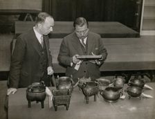 Zheng Tianxin (Dr F. T. Cheng) and Mr F.St. G. Spendlove examining exhibits, 1935. Creator: Topical Press Agency