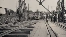 Zimbabwe: people and a flag-covered train at the opening of Victoria Bridge, 1905. Creator: J Lomas