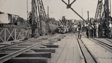 Zimbabwe: people and a flag-covered train at the opening of Victoria Bridge, 1905. Creator: J Lomas
