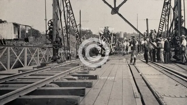 Zimbabwe: people and a flag-covered train at the opening of Victoria Bridge, 1905. Creator: J Lomas.